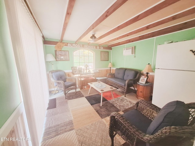 living room with ceiling fan and beamed ceiling