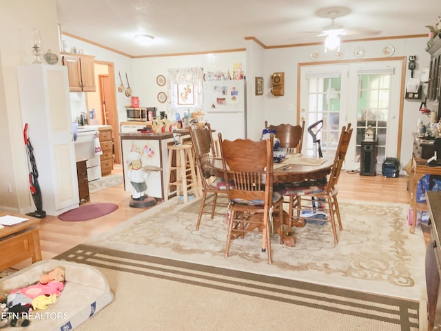 dining area featuring light hardwood / wood-style floors, ceiling fan, and crown molding