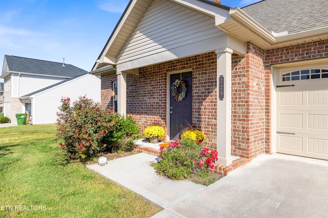 view of front of home with a front yard and a garage