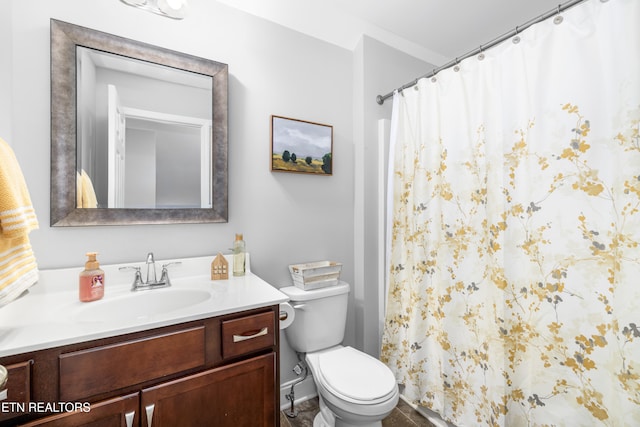 bathroom featuring vanity, toilet, and curtained shower