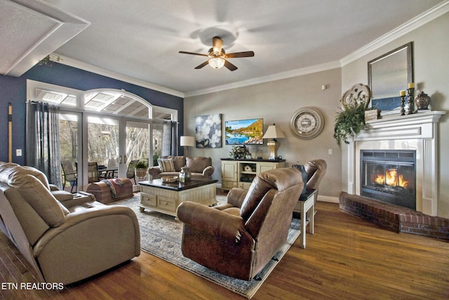 living room with ornamental molding, a fireplace, dark hardwood / wood-style floors, and ceiling fan