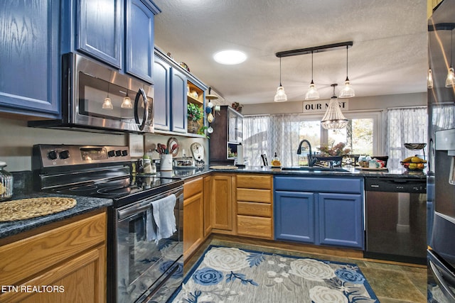 kitchen with appliances with stainless steel finishes, blue cabinetry, sink, and hanging light fixtures