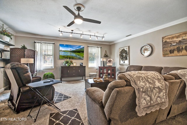 carpeted living room featuring ornamental molding, a textured ceiling, track lighting, and ceiling fan