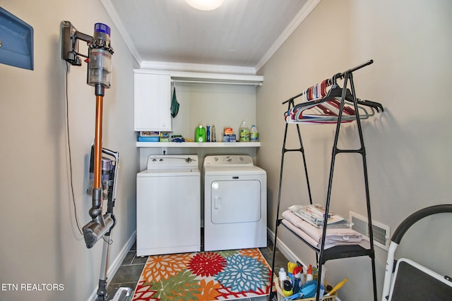 laundry room featuring crown molding, separate washer and dryer, and dark tile patterned flooring