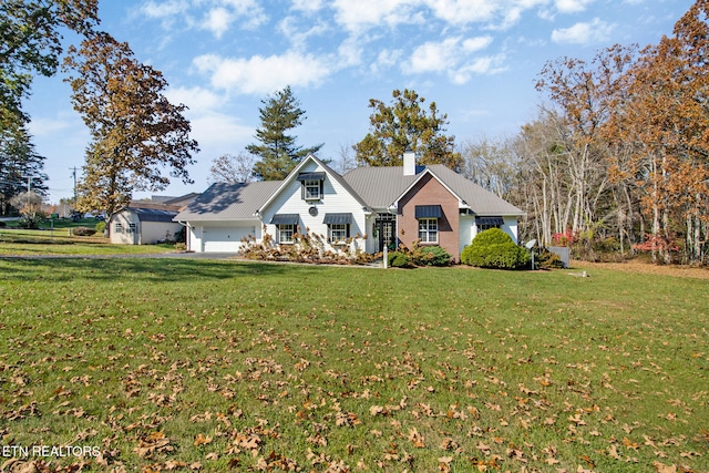 view of front of home with a front lawn and a garage