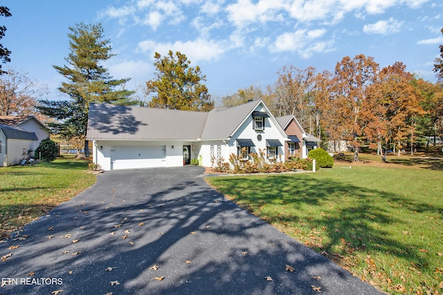 view of front of home with a front yard and a garage