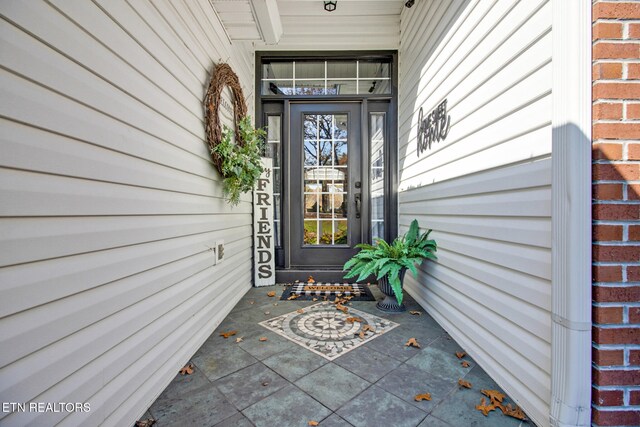 entrance to property featuring covered porch