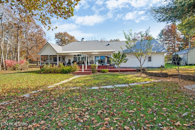 back of house with a yard and a porch