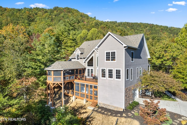 back of house featuring a sunroom