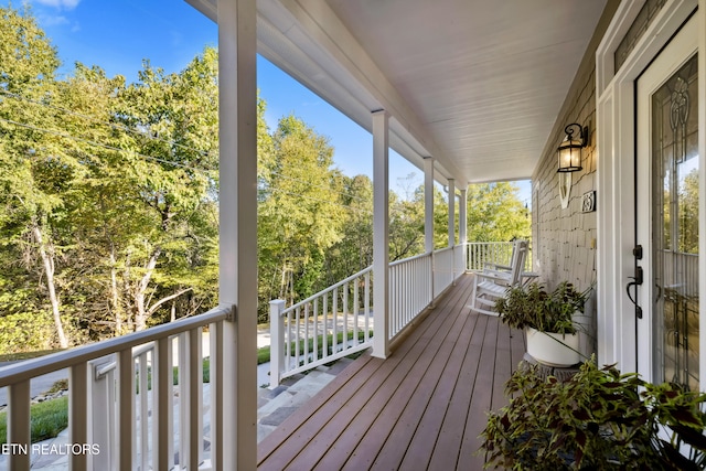 wooden terrace with a porch