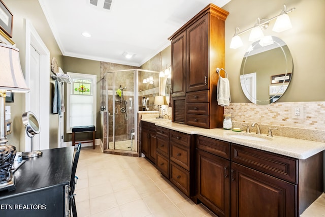 bathroom featuring vanity, crown molding, tasteful backsplash, and walk in shower