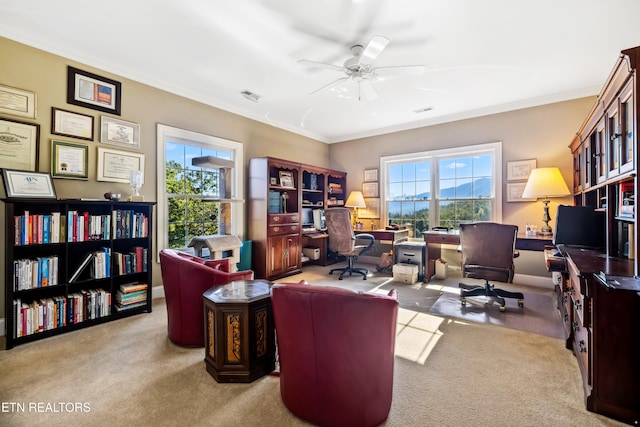 office space with crown molding, light colored carpet, and ceiling fan