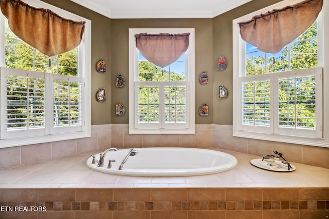 bathroom featuring a relaxing tiled tub, plenty of natural light, and crown molding