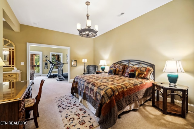 bedroom with a chandelier and light colored carpet