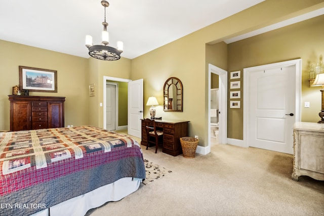 carpeted bedroom featuring ensuite bathroom and a chandelier