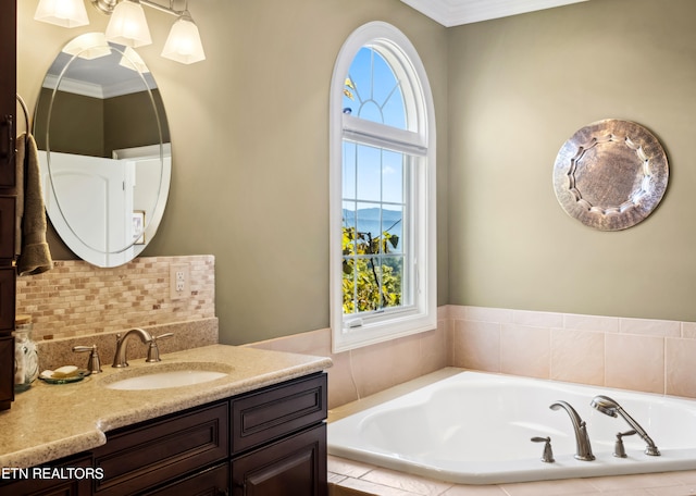 bathroom featuring vanity, crown molding, a healthy amount of sunlight, and tiled tub