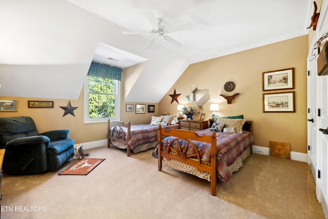 bedroom featuring vaulted ceiling, light colored carpet, and ceiling fan