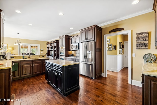 kitchen with ornamental molding, appliances with stainless steel finishes, dark brown cabinets, and dark hardwood / wood-style flooring