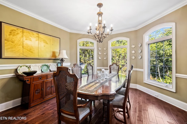 dining area with crown molding, dark hardwood / wood-style floors, and an inviting chandelier