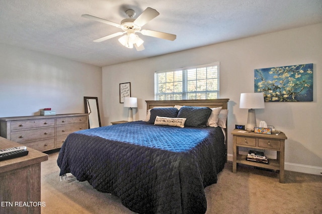 carpeted bedroom featuring a textured ceiling and ceiling fan