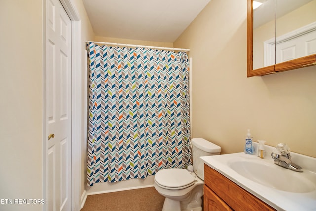 bathroom featuring vanity, toilet, and a shower with curtain