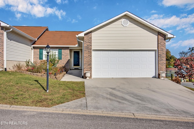 single story home featuring a front lawn and a garage