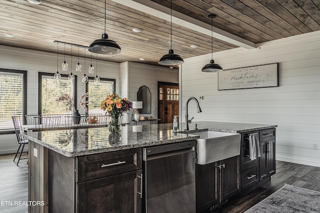 kitchen with dishwasher, hanging light fixtures, dark hardwood / wood-style floors, and wood walls