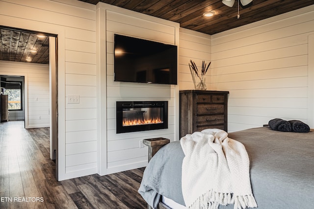 bedroom featuring wood ceiling, wood walls, and dark wood-type flooring