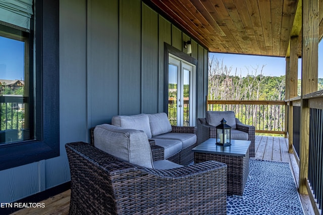 wooden terrace featuring french doors and outdoor lounge area