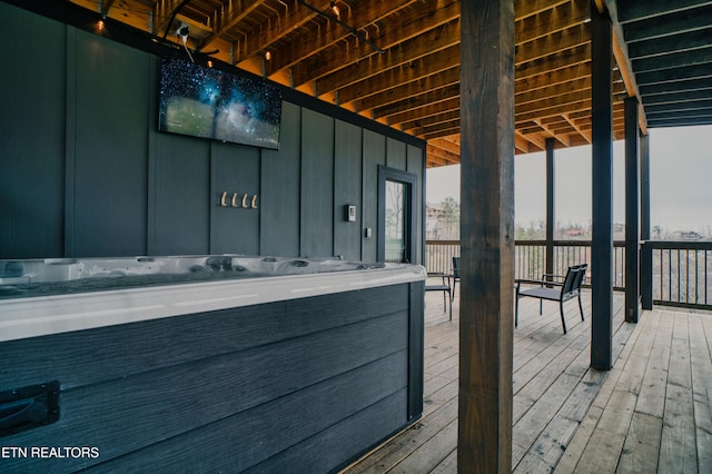 wooden terrace featuring a hot tub