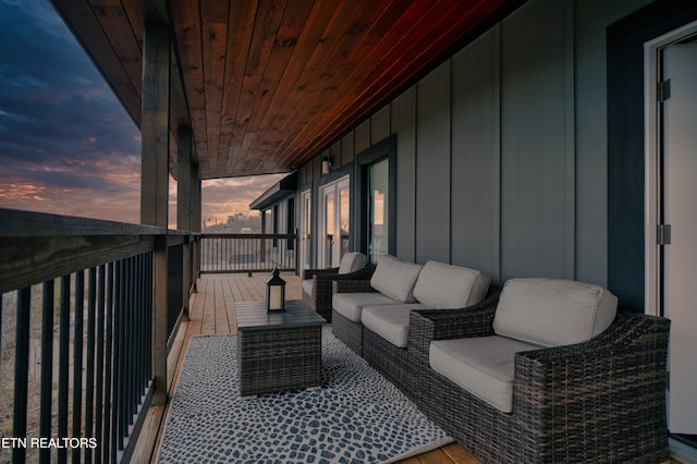 balcony at dusk featuring outdoor lounge area