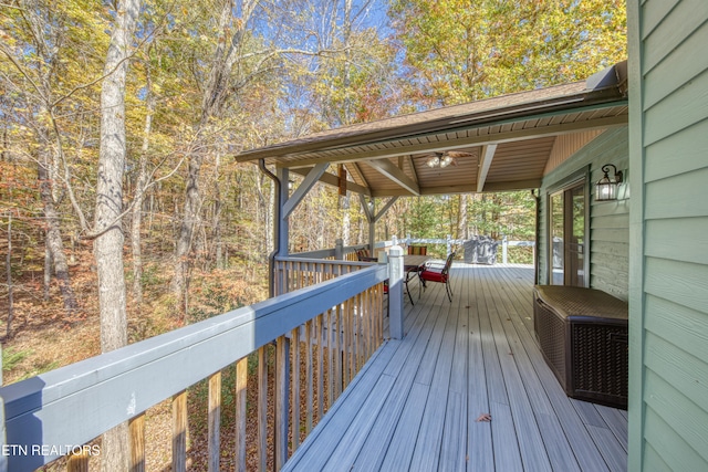 wooden deck featuring ceiling fan