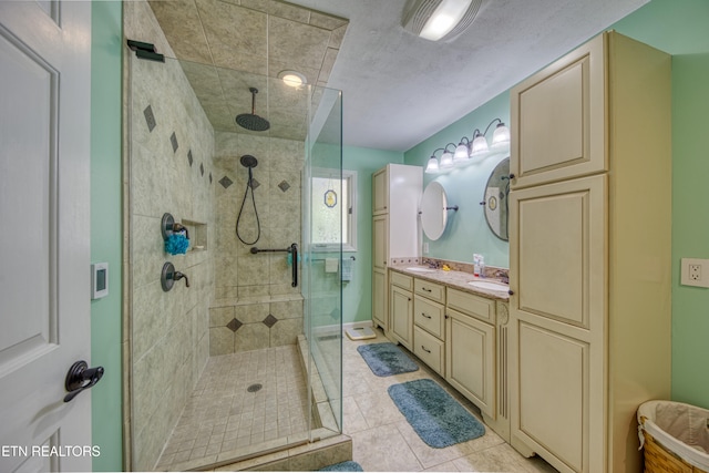 bathroom with vanity, walk in shower, and tile patterned flooring