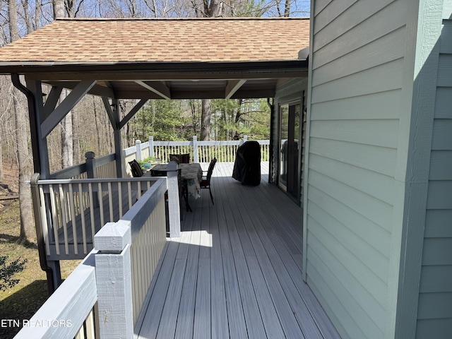 wooden deck with outdoor dining space