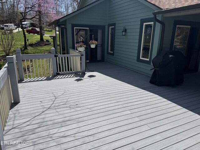 wooden deck with a grill