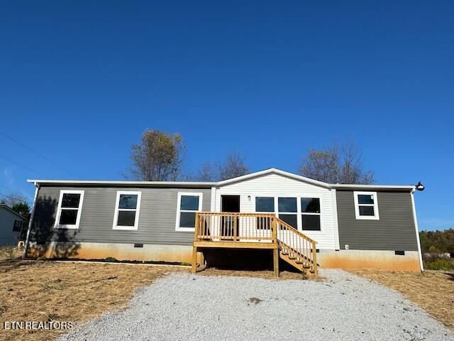 view of front of home featuring a wooden deck