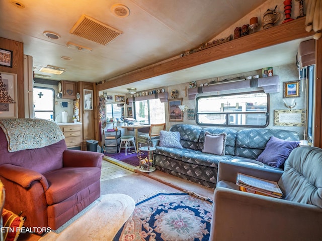 living room with carpet and vaulted ceiling