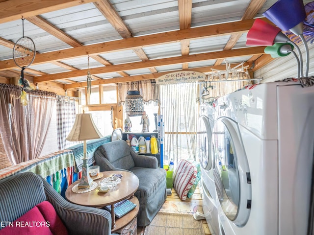 interior space with beam ceiling and independent washer and dryer