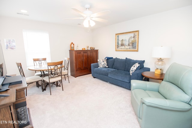 living room featuring ceiling fan and light colored carpet