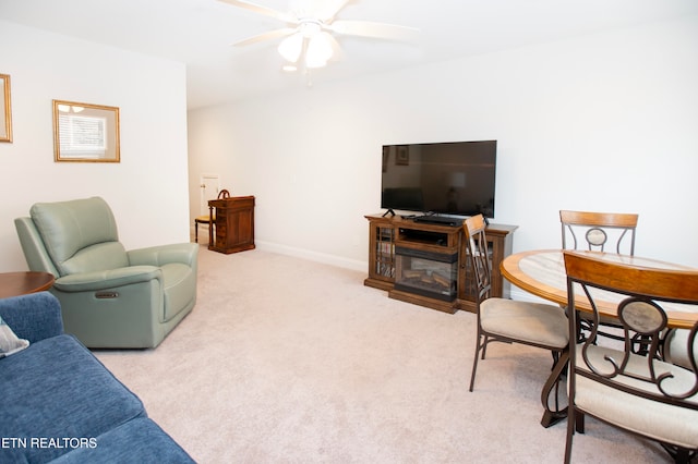 carpeted living room featuring ceiling fan