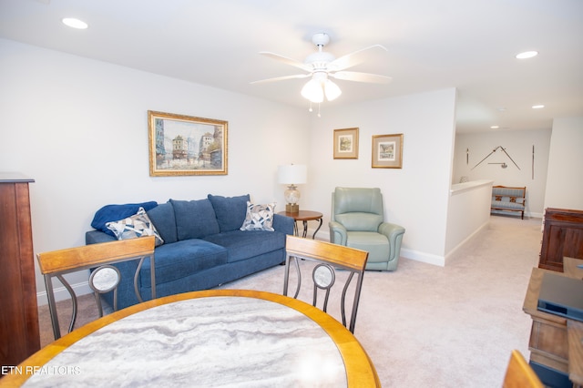 living room featuring light carpet and ceiling fan