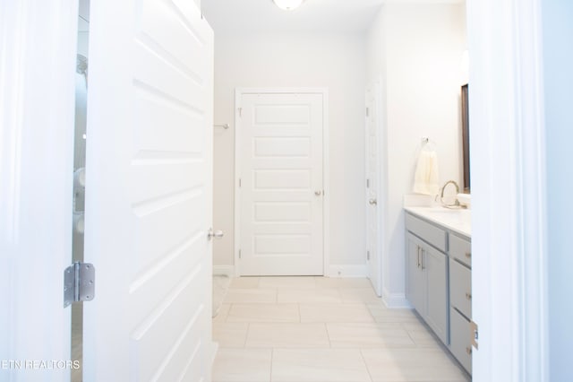 bathroom with tile patterned flooring and vanity