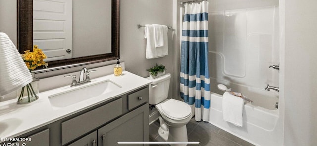 full bathroom featuring tile patterned floors, shower / bath combo with shower curtain, vanity, and toilet