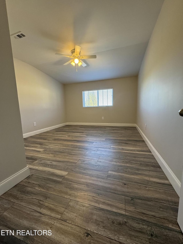 empty room featuring ceiling fan and dark wood-type flooring