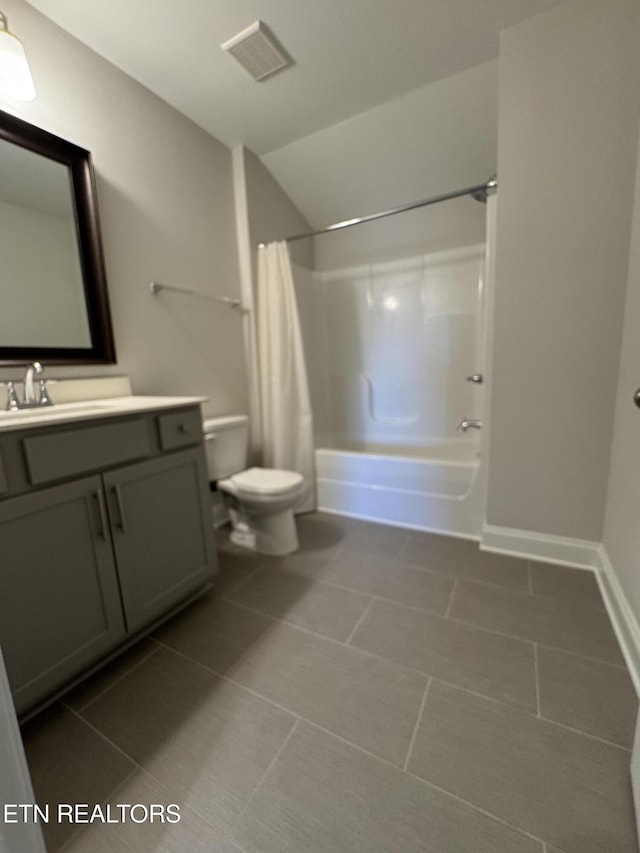 full bathroom with tile patterned flooring, vanity, toilet, and shower / bath combo with shower curtain