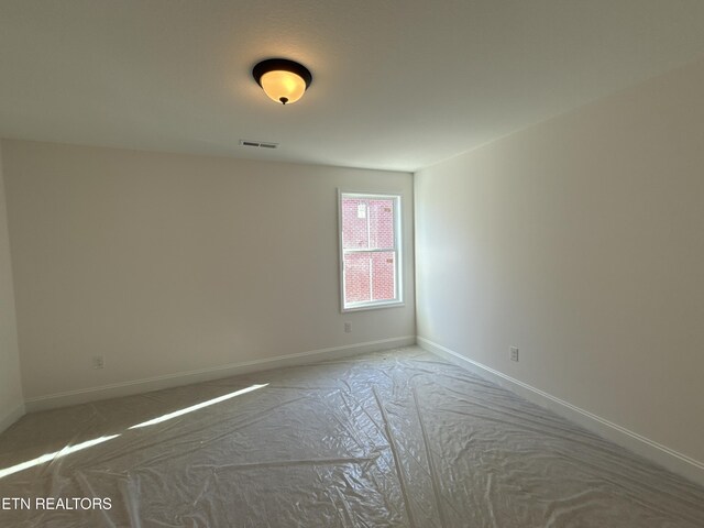 empty room featuring visible vents and baseboards