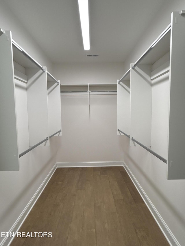 walk in closet featuring dark wood-type flooring and visible vents