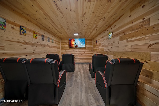 cinema room with wood walls, wood ceiling, and hardwood / wood-style floors