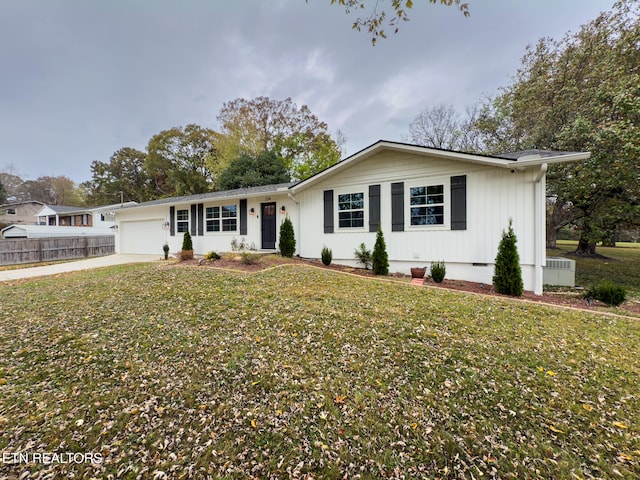 single story home with a garage and a front lawn