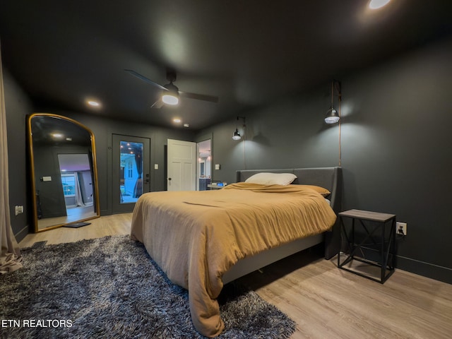 bedroom featuring ceiling fan, light wood-type flooring, and access to outside